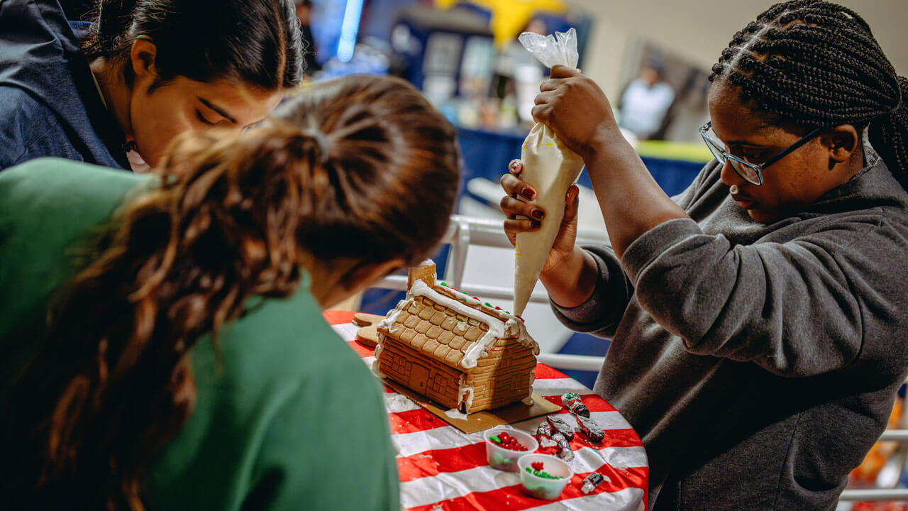Students work together at gingerbread stations in the Carl Hansen Student Center