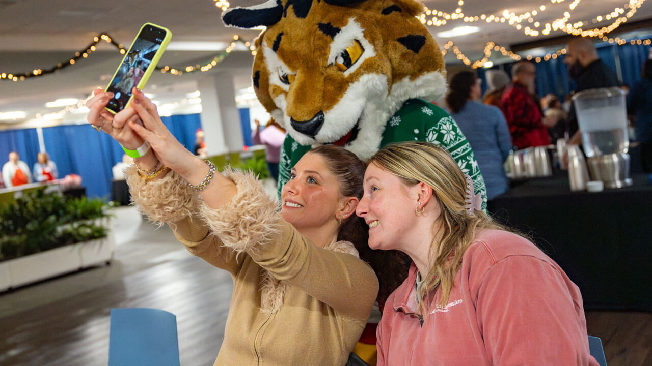 Students take a selfie with boomer