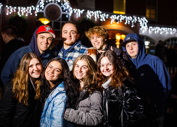 Students smile at the holiday lighting.