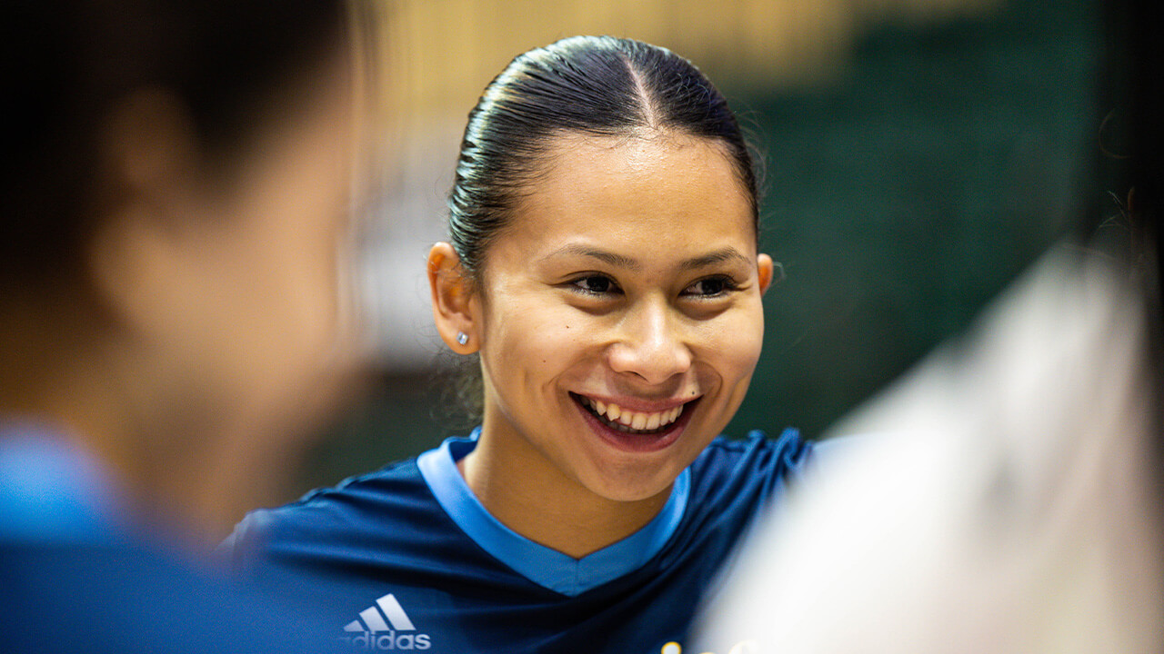Chloe Ka'ahanui smiling in a team huddle.
