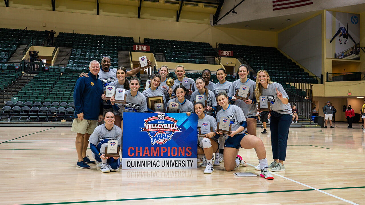 The team poses for a photo on the court after winning the MAAC Finals.