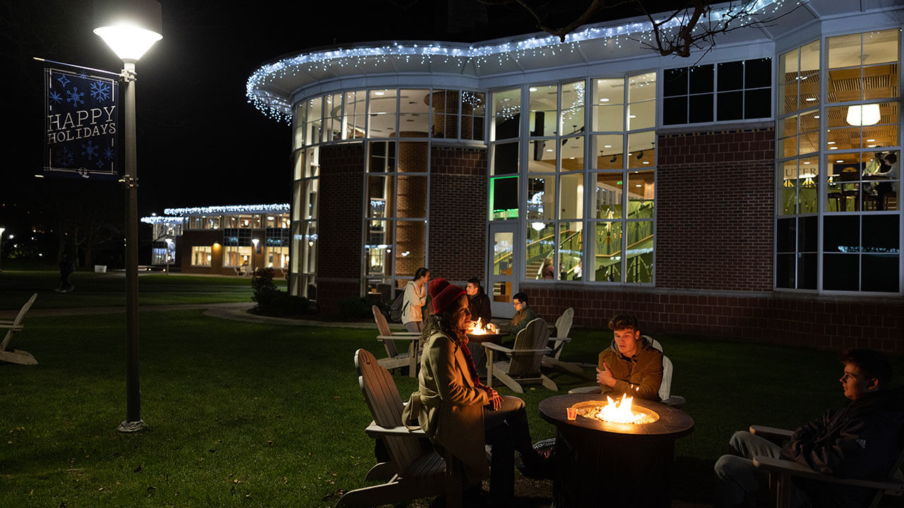Students warm up on the Quad and use the fire pits