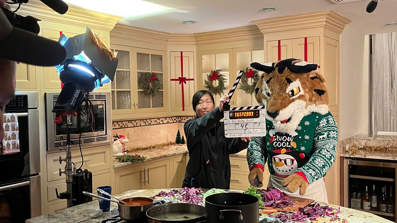 Boomer the Bobcat on set with a crew member in the kitchen