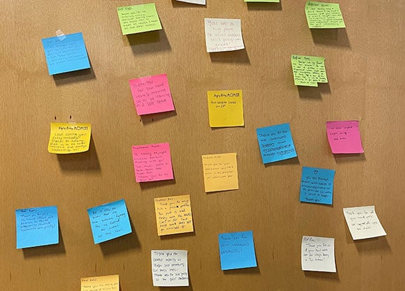Sticky notes with heartfelt messages to faculty on doors