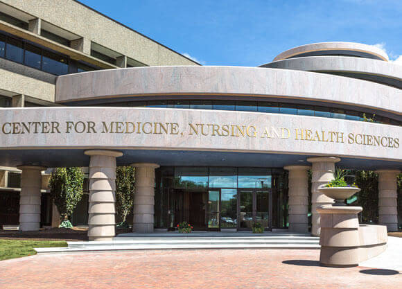 Entrance to the Center for Medicine, Nursing and Health Sciences during the day