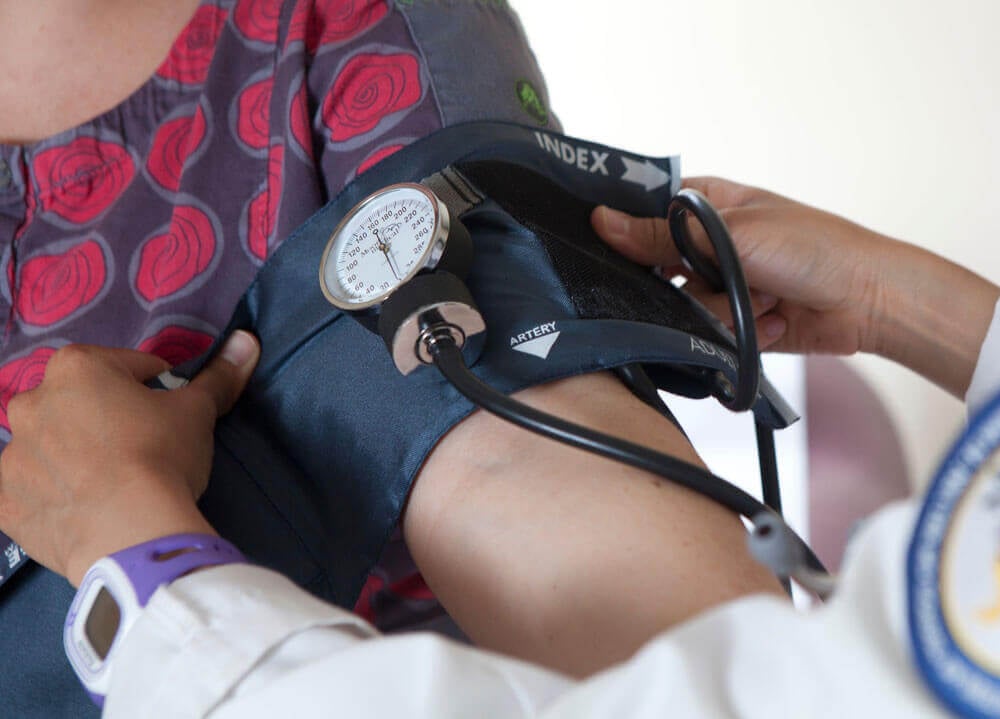 Pre-med student practices using a  blood pressure cuff