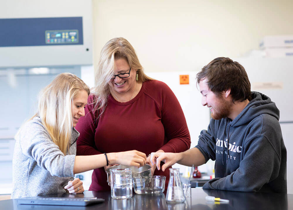 A biology professor instructs her students through a laboratory procedure in the Buckman Center Biology Lab on the Mount Carmel Campus