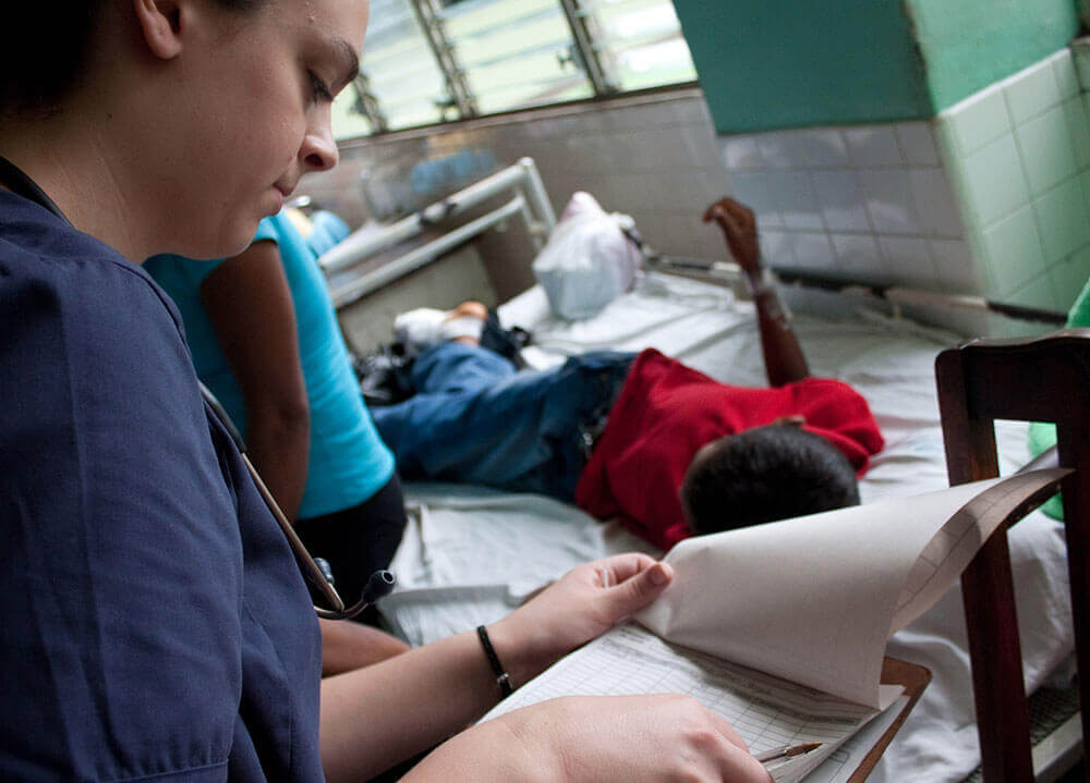 A nursing student checks her notes on a clipboard at a clinic in Nicaragua
