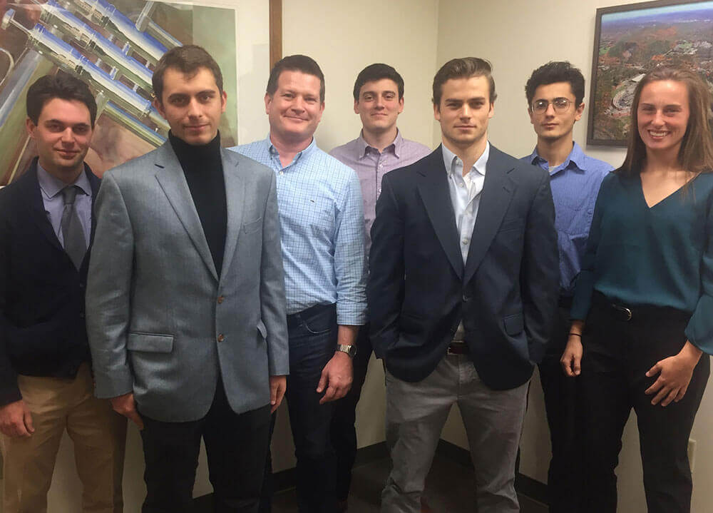Six members of the Quinnipiac Economics Research Club pictured with Professor Chris Ball