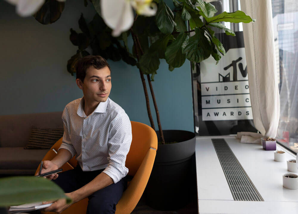 Student sits in an office at in his internship at Viacom in New York City