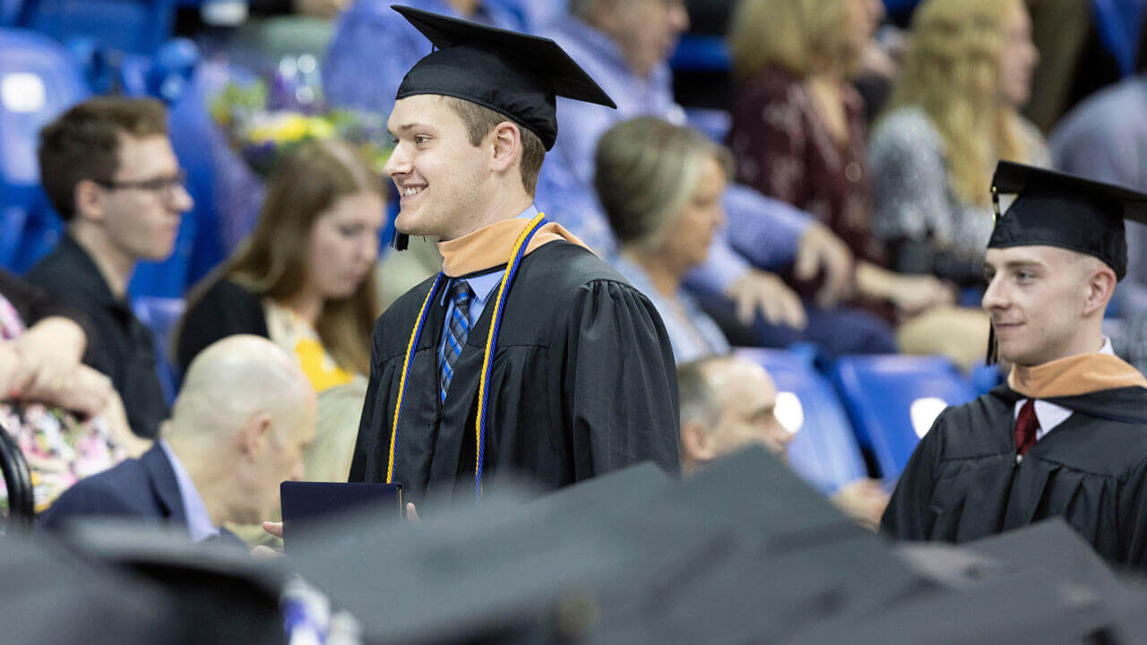 Brendan Frank wearing a cap and gown during Commencement