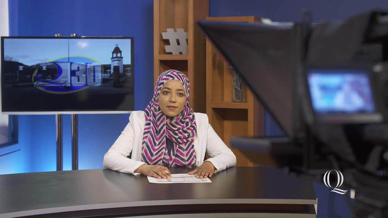 Image shows journalism student Ayah Galal hosting the Q30 student news show, intro to video