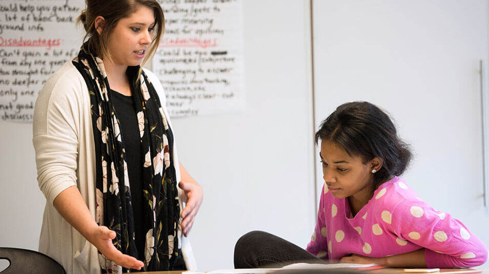 A School of Education student assists a New Haven high school student with her civics coursework