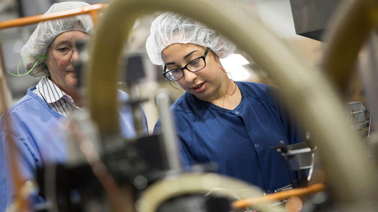 Alisson Gil '18 inspects the equipment on the production floor at Aptar in Stratford, Connecticut during her summer internship.