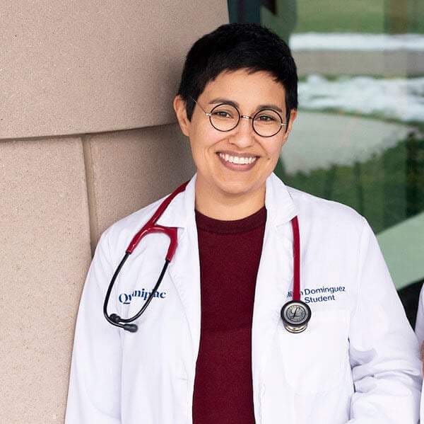 Photo of Delilah Dominguez wearing a Quinnipiac branded white coat