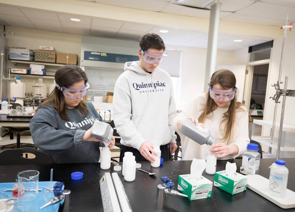 Student employees assist in a laboratory experiment in Buckman Center