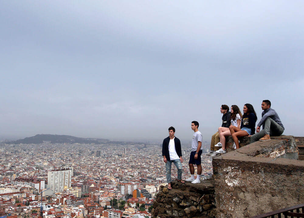 Students take a tour at  Bunker of Carmel with a view of the skyline in Barcelona, Spain.