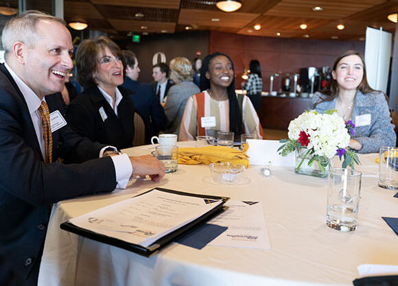 people around a table at a Quinnipiac networking event