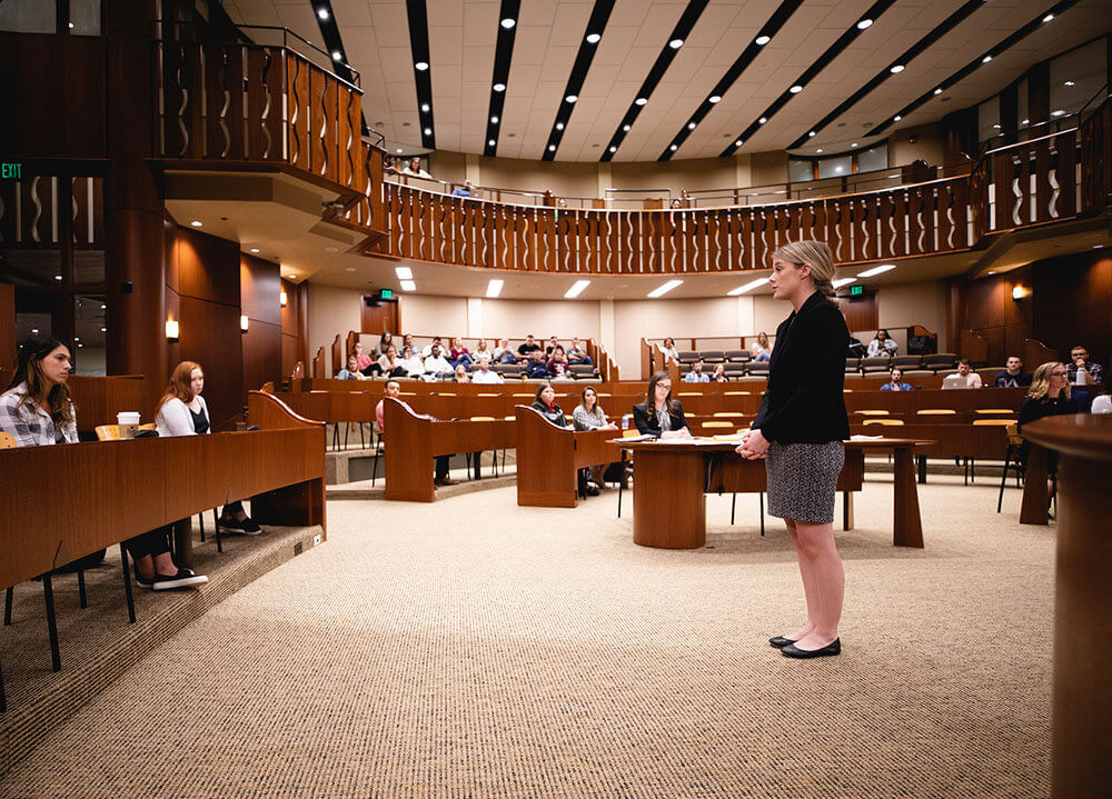 A first-year law student makes opening statements to the jury during a mock trial