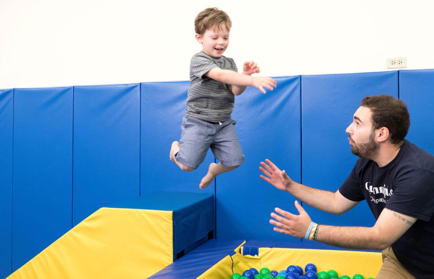 Child jumping in ball pit