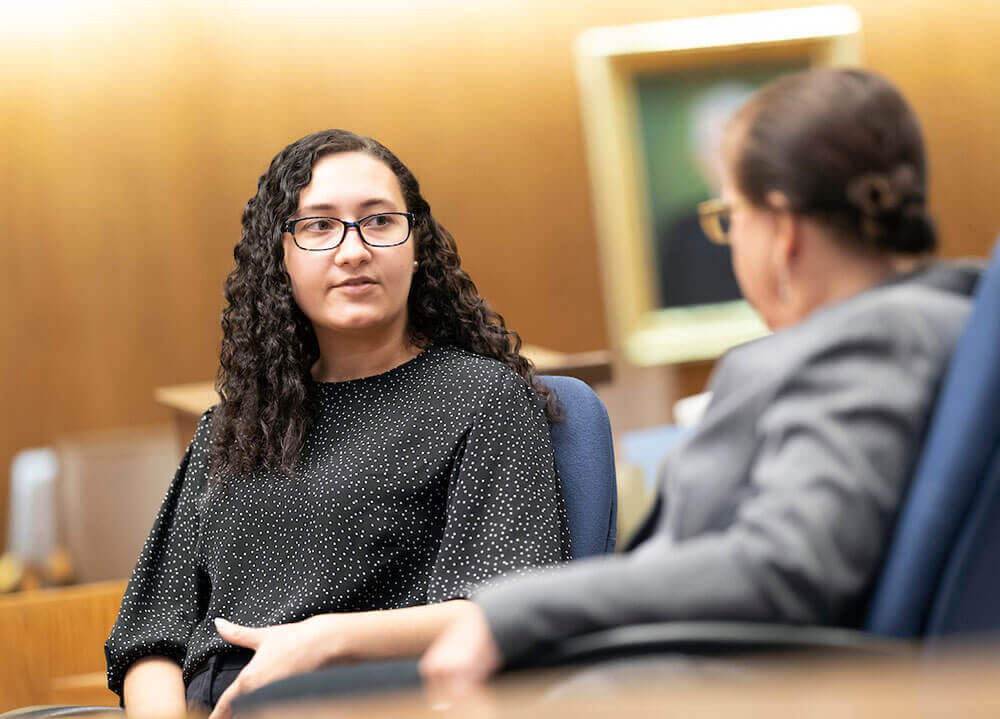 A law student converses with a public defender at New Haven Superior Court
