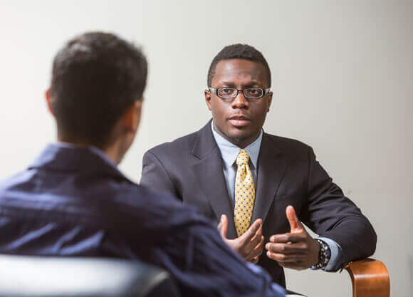 Two graduate students talk together