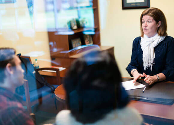 An admissions counselor meets with a prospective undergraduate student