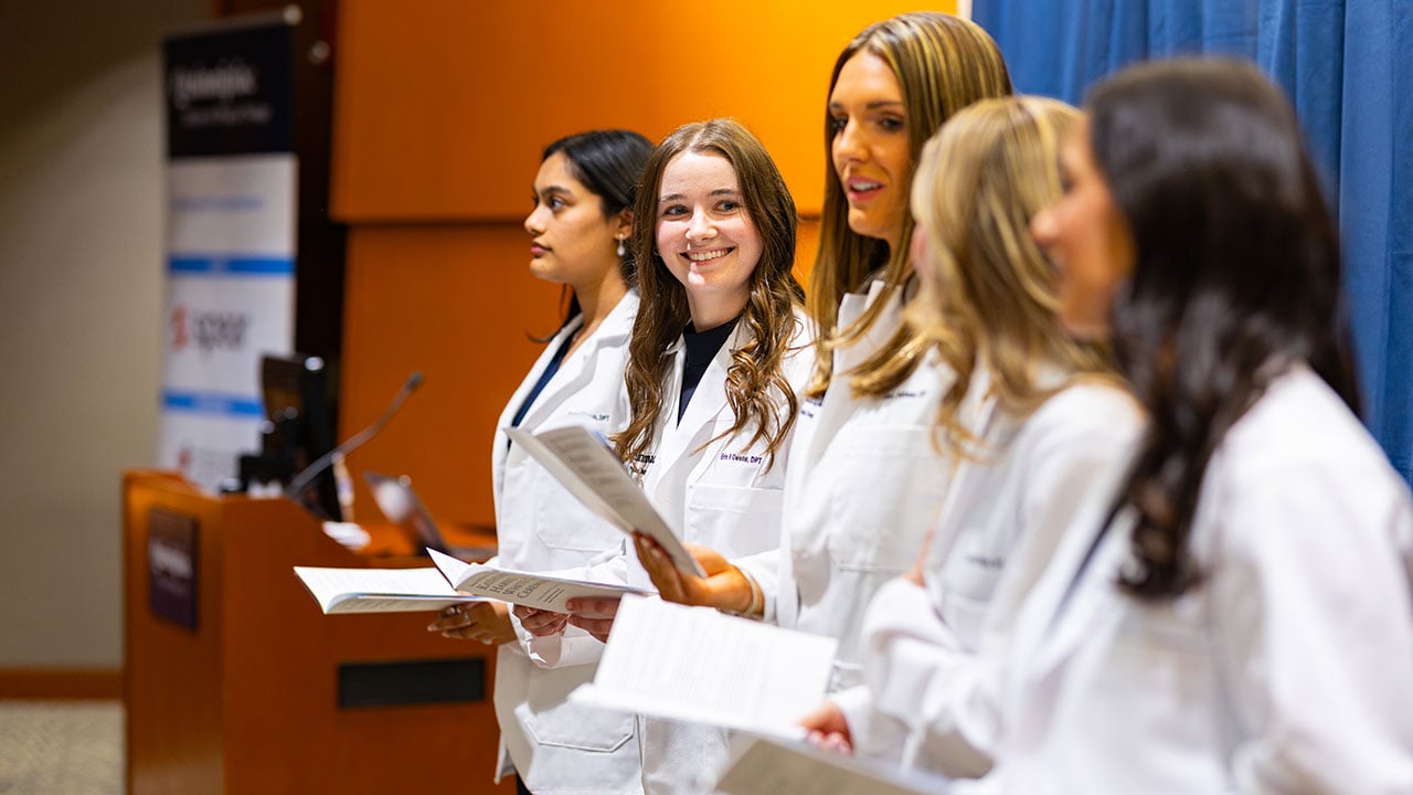 Student smiles at peers