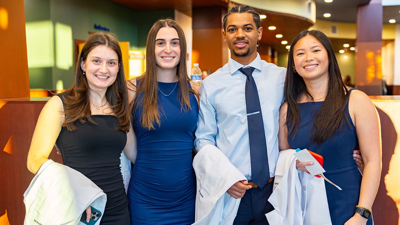 Students pose together at White Coat Ceremony