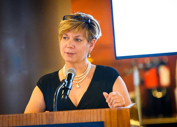 Kathy Harris speaking at a podium