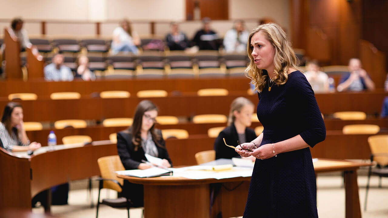 Caitlin Murphy in a mock courtroom, speaking to a mock jury