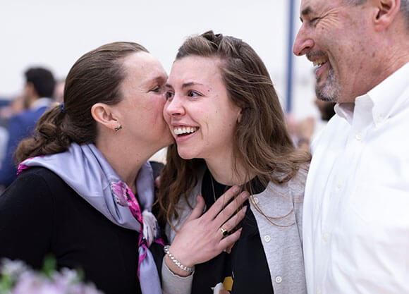 Molly Clarke, MD '19, celebrate with her parents.