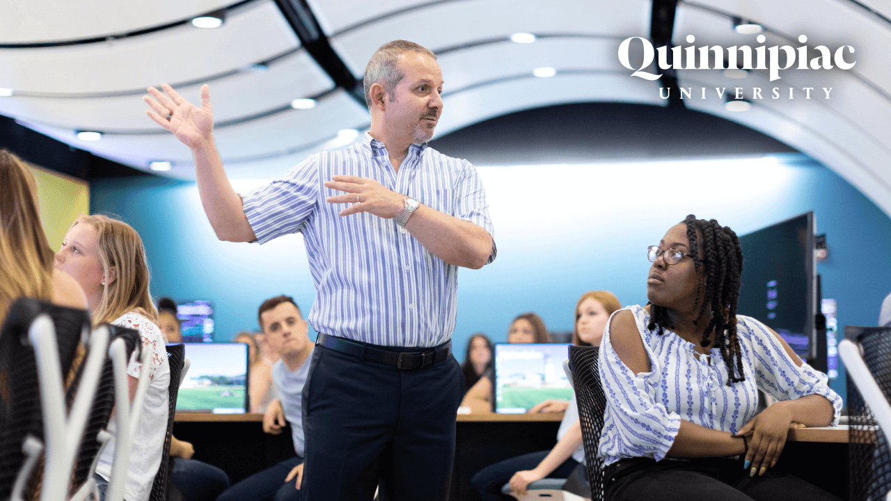 A business professor lectures in the Financial Technology Center, starts video