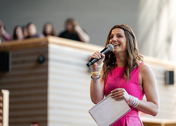 Alison Feller speaks into a microphone